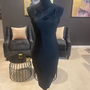 Black formfitting dress with cross strap detail in front
